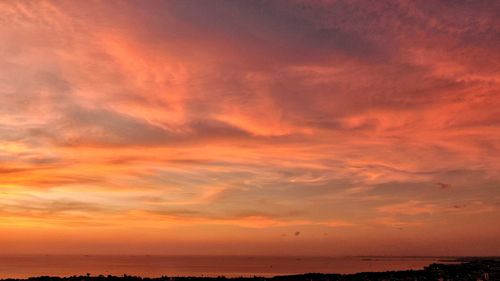 Scenic view of sea against romantic sky at sunset