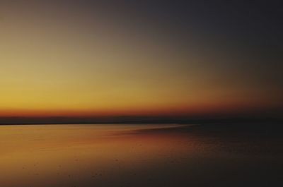 Scenic view of sea against romantic sky at sunset