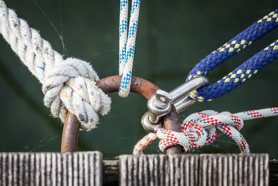 Close-up of ropes tied on bollard