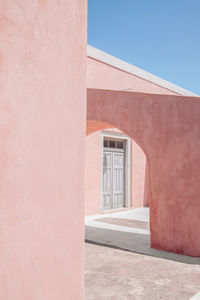 Entrance of building against clear blue sky