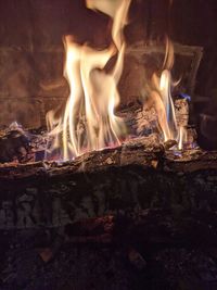 Bonfire on wooden log at night