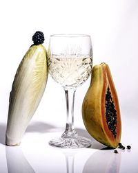 Close-up of fruits on table against white background