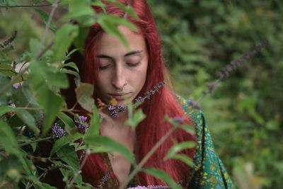 Portrait of young woman standing in a field of lillies