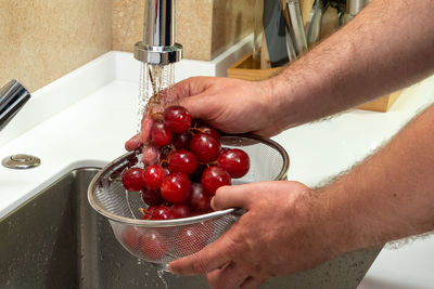 Midsection of man washing hands