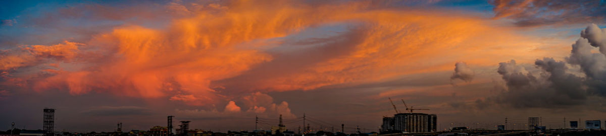 Low angle view of buildings against dramatic sky