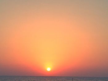 Scenic view of sea against orange sky