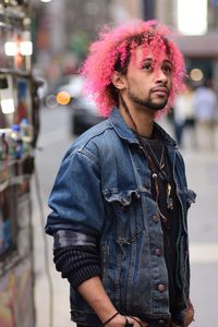 Young man with dyed hair standing on street