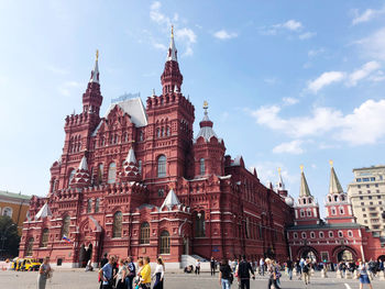 Group of people in historic building against sky