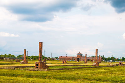 Built structure on field against sky