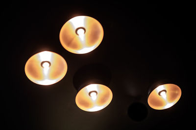 Close-up of lit candle in darkroom