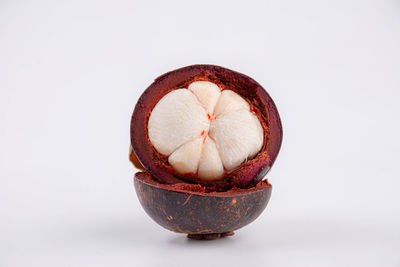 Close-up of strawberry in bowl against white background