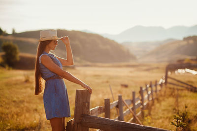 View of woman standing on field against sky