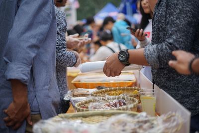 Midsection of people at market