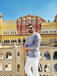 View of a man standing against hawa mahal palace