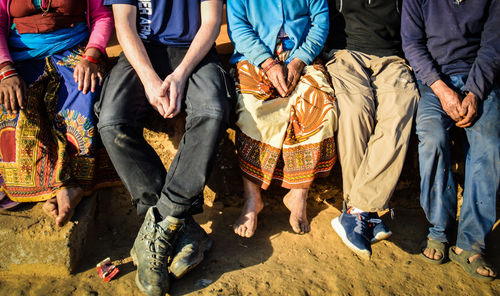 Low section of family sitting at beach