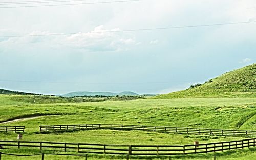 Scenic view of agricultural field against sky