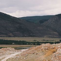 Scenic view of mountains against cloudy sky