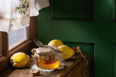 Close-up of quinces with honey on table