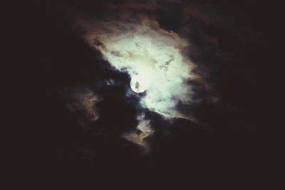 Low angle view of cloudy sky at night