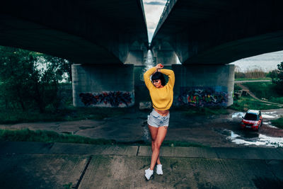 Full length of woman standing in tunnel