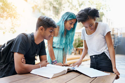 Cheerful friends studying at campus