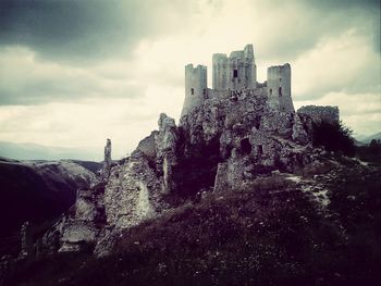 Low angle view of building against cloudy sky
