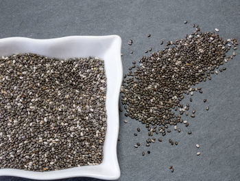 High angle view of seeds in bowl and slate