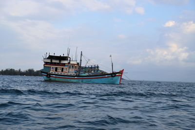 Boat sailing in sea against sky