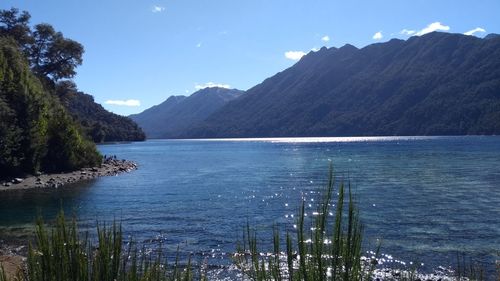 Scenic view of sea and mountains against sky