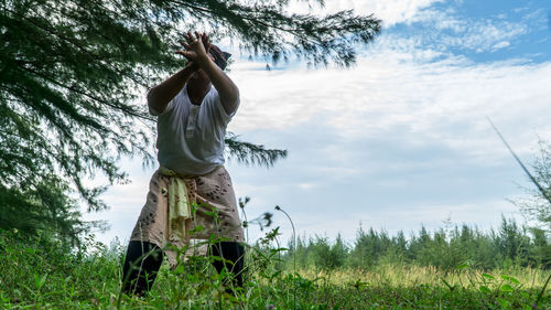 Man standing on agricultural field against sky