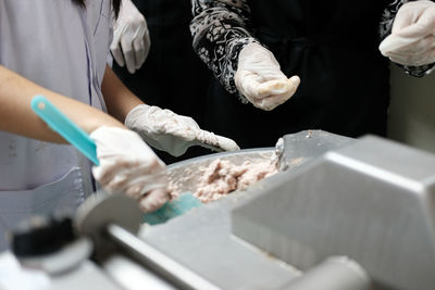 People working on cutting board