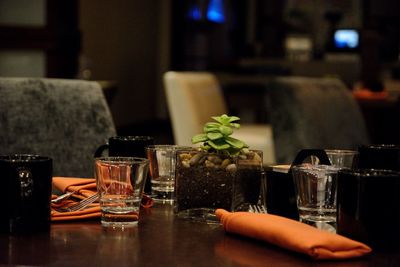 Close-up of wine glasses on table