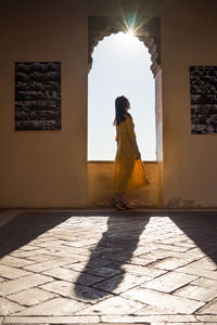 Female traveler in arch of old fortress