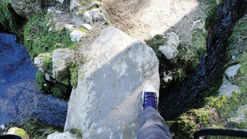 Low section of person standing on rock