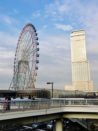 Ferris wheel in city against sky