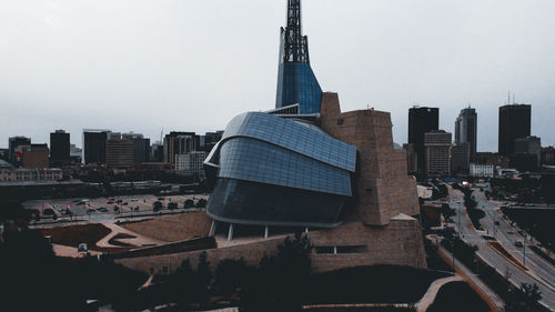 Modern buildings in city against clear sky