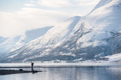 Scenic view of lake against mountains during winter