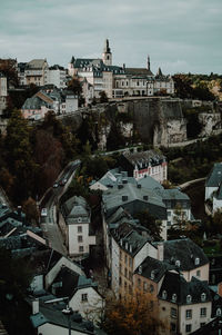 High angle view of buildings in town against sky