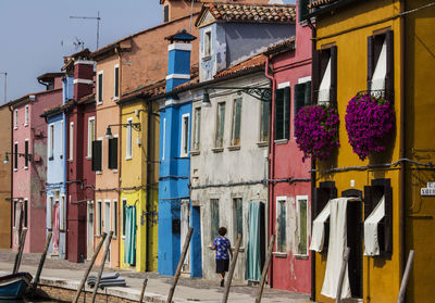 Man hanging on window of building