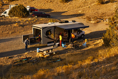 Guys setting up camp in a motorhome.