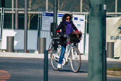 Portrait of man riding bicycle on road