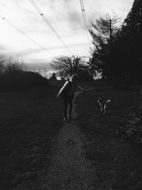 Dog standing on field against sky