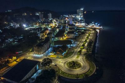 High angle view of illuminated buildings in city at night