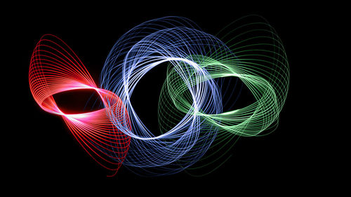 Multi colored light painting against black background