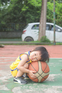Young woman playing basketball in park