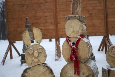 Close-up of clothes hanging on wooden post in winter
