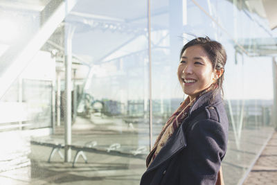 Portrait of smiling young woman standing outdoors