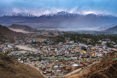 High angle view of townscape and mountains against sky