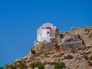 Low angle view of built structure against clear blue sky