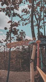 Low angle view of text on tree against sky